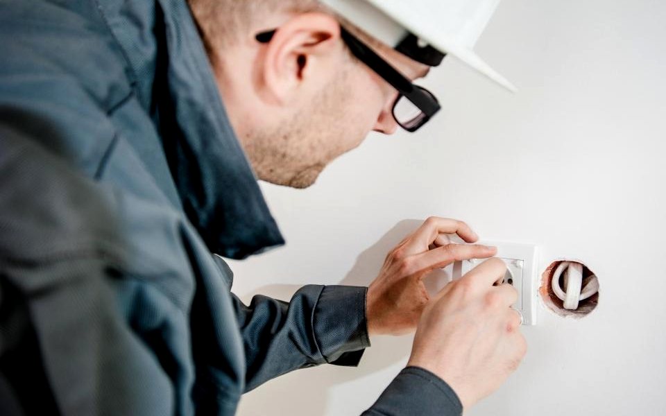 Electrician fitting a wall socket