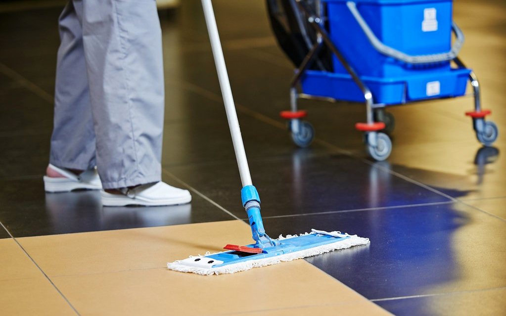 Floor being mopped with a professional cleaning trolley